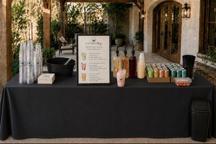 CottonTop Drop, Set and Go setup with black tablecloth, black ice bucket, three-drink menu and complete serving supplies