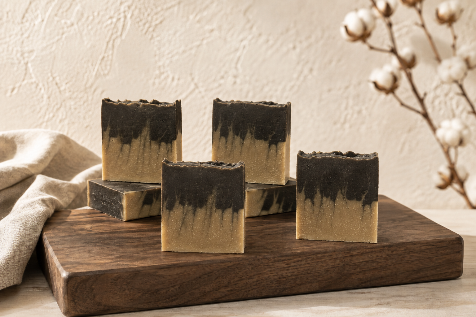 Several unwrapped Carbon and Clay facial bars displayed at their natural scale on a walnut board